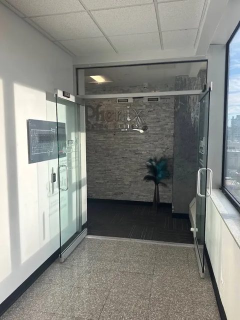 The glass entrance to Phenix Salon Suites